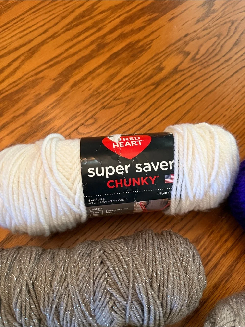 Super Saver Yarn Bundle in Purple, Black, white, gray metallic, and brown.